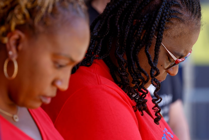 Allisa Charles-Findley, (left) Botham Jean's sister, and Allison Jean, Jean's mother, pray...