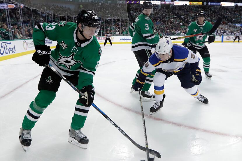 Dallas Stars defenseman Esa Lindell (23,) of Finland, attempts to gain control of the puck...