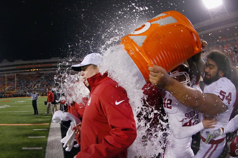 STILLWATER, OK - NOVEMBER 28: Head coach Bob Stoops of the Oklahoma Sooners is soaked with a...
