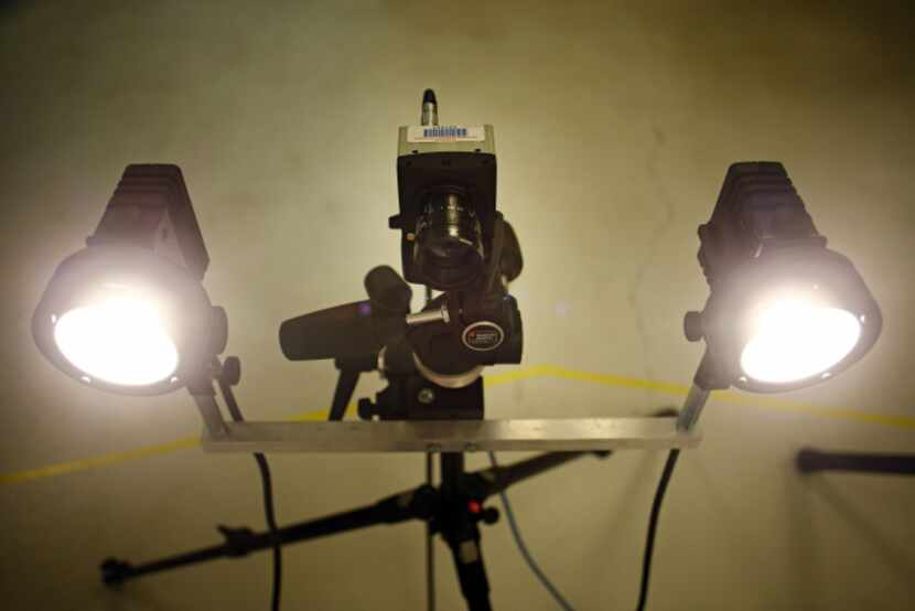 Bright lights flank a high-speed camera during a demonstration on the physics of flopping at...