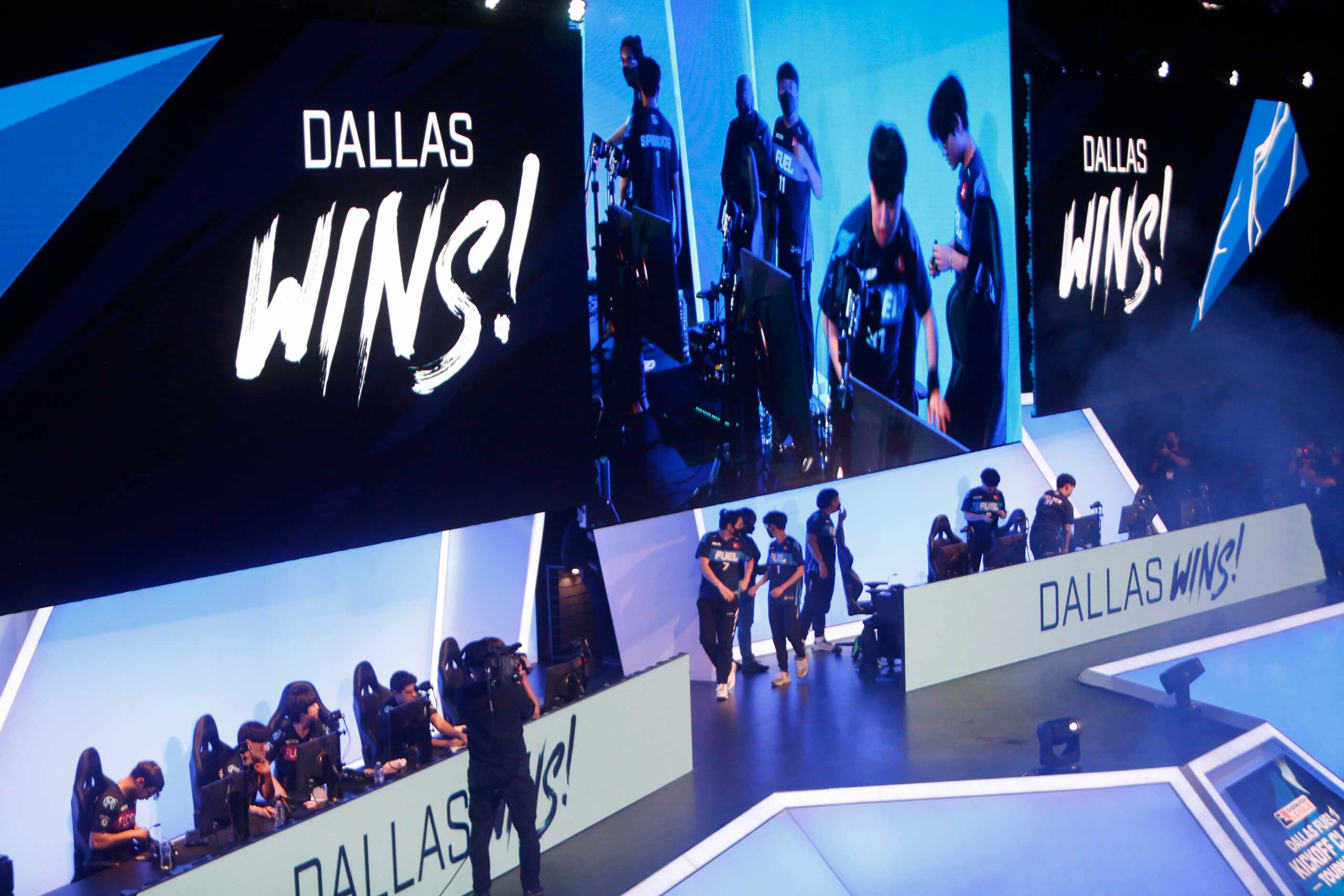 Esports teams prepare to leave the stage after Dallas Fuel players, right, defeated Florida...
