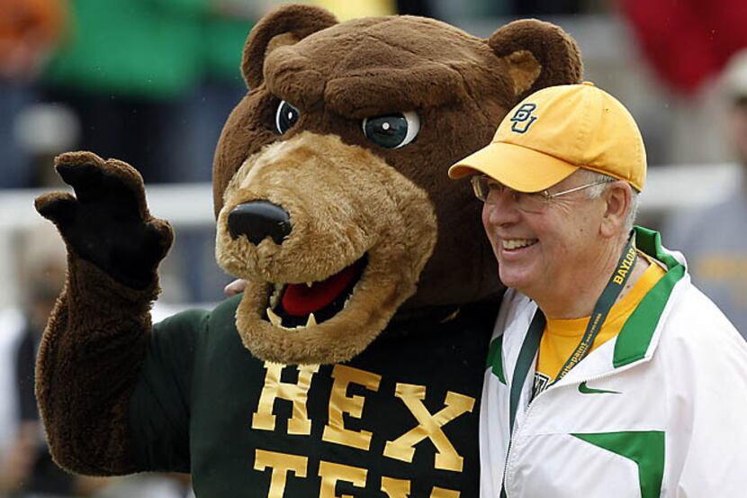 Baylor University President Ken Starr poses with Bruiser before a football game at Floyd...