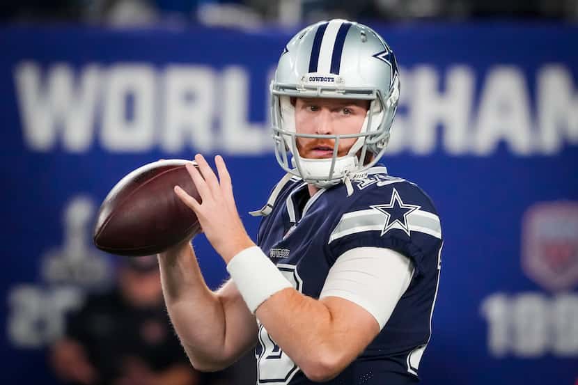 Dallas Cowboys quarterback Cooper Rush warms up before an NFL football game against the New...