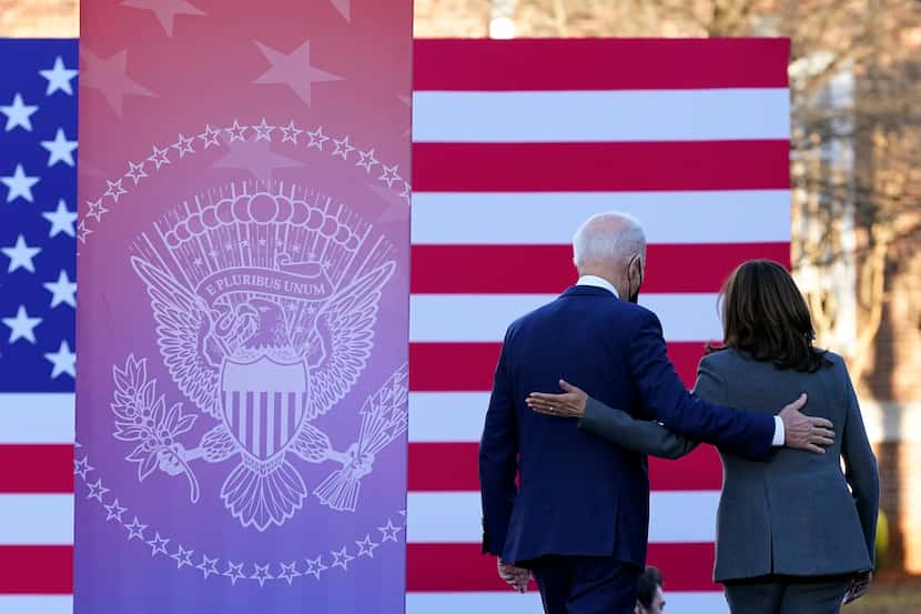 President Joe Biden and Vice President Kamala Harris walk off stage after speaking in...