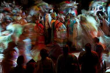 People from Native American tribes from across the U.S. wear their dancing regalia as they...