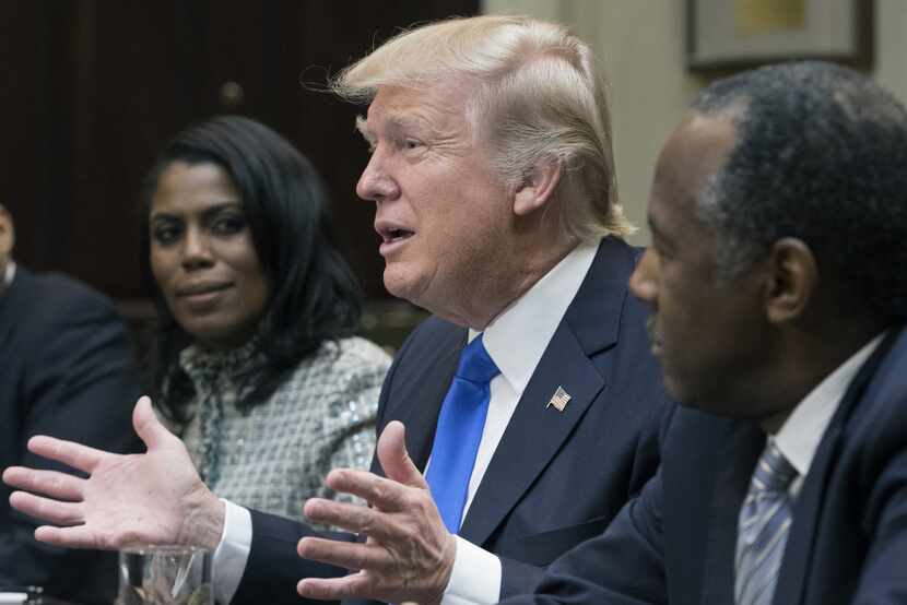 Trump, accompanied by communications aide Omarosa Manigault and Ben Carson, his pick for...