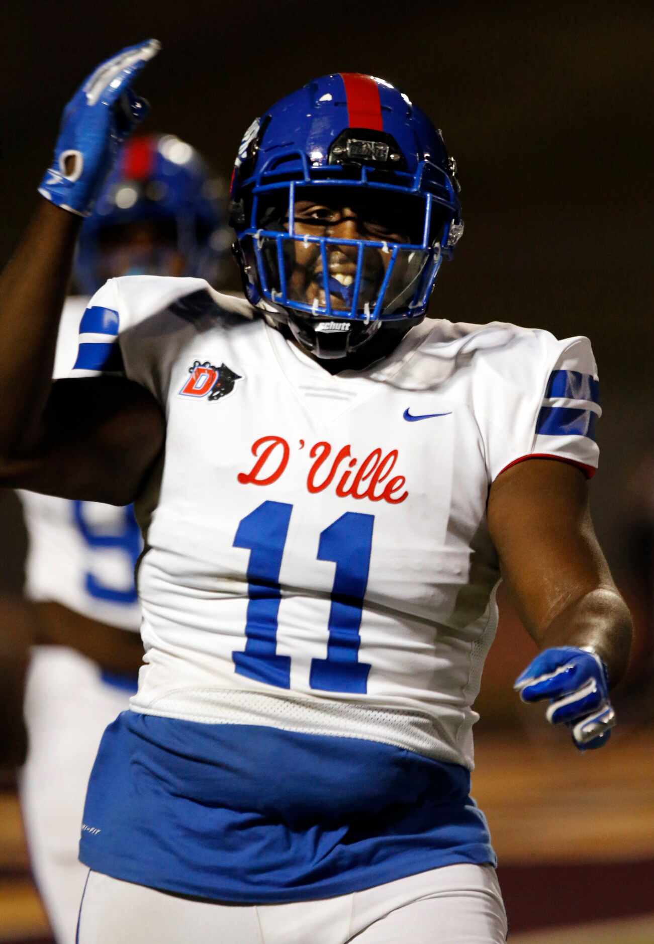 Duncanville’s Tyler Quinn (11) is happy after taking a interception to the end zone for a...