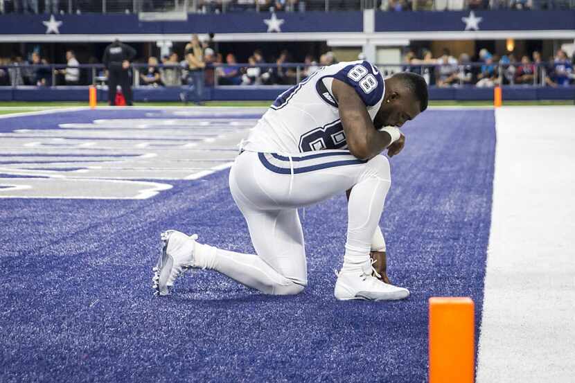 Dallas Cowboys wide receiver Dez Bryant (88) prays in the end zone before facing the...