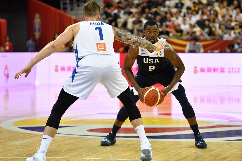 Harrison Barnes of the US holds the ball next to Patrik Auda of the Czech Republic during...