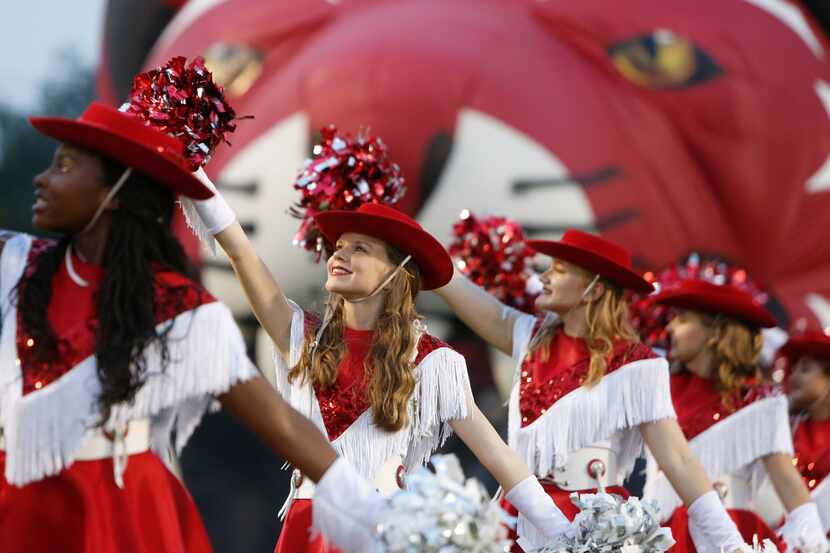 Members of the Lake Highlands drill team perform on the field prior to the start of their...