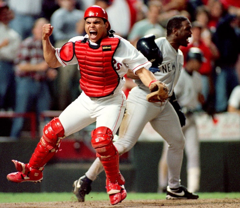 Ivan (Pudge) Rodriguez celebrates tagging out Tim Raines at the plate during game 3 of the...