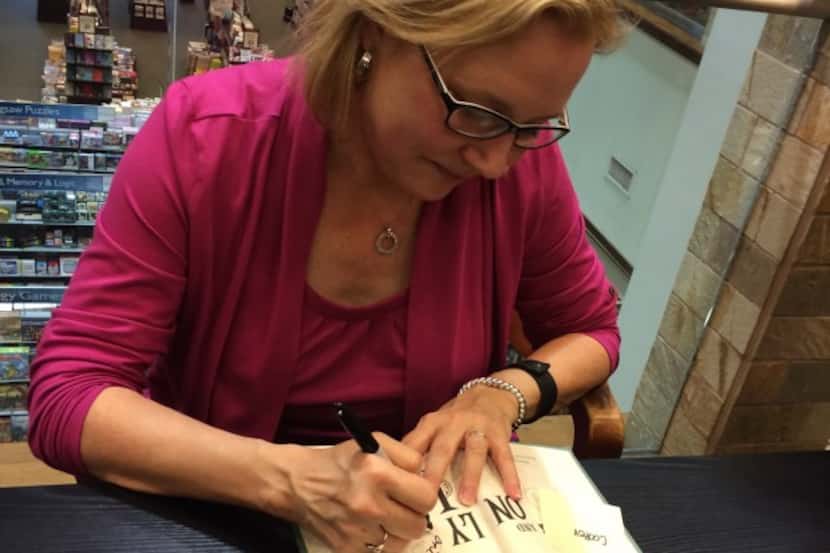  Katherine Applegate signs a copy of "The One and Only Ivan" Monday at Barnes & Noble in...