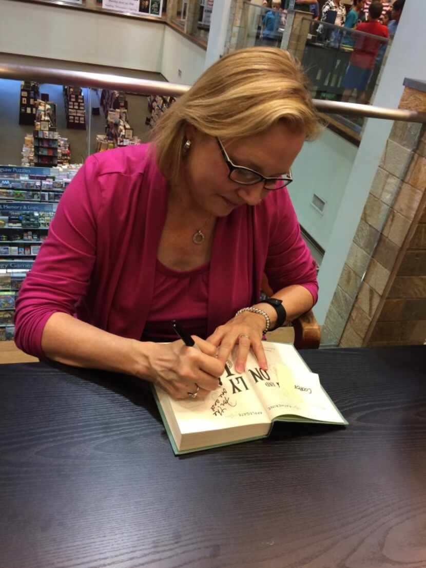  Katherine Applegate signs a copy of "The One and Only Ivan" Monday at Barnes & Noble in...