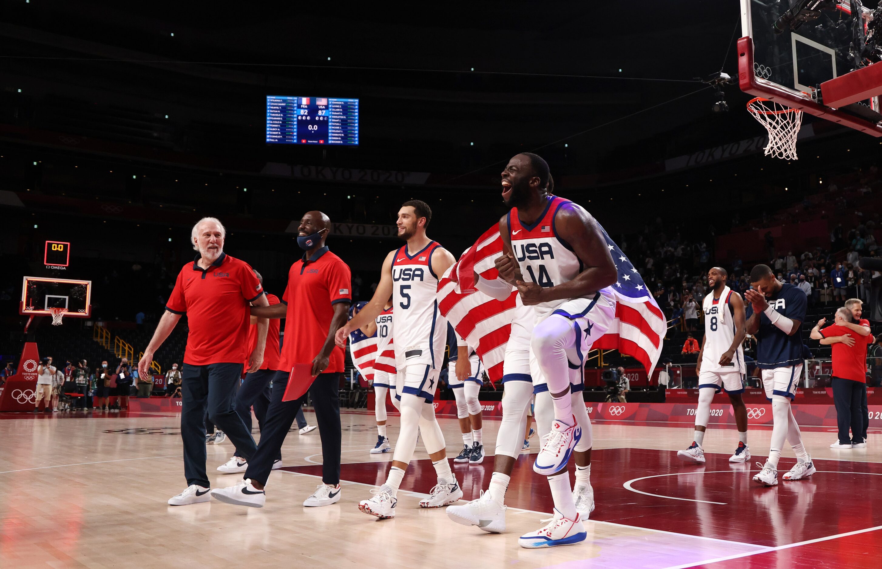 USA’s Draymond Green (14) celebrates with teammates after defeating France in the gold medal...