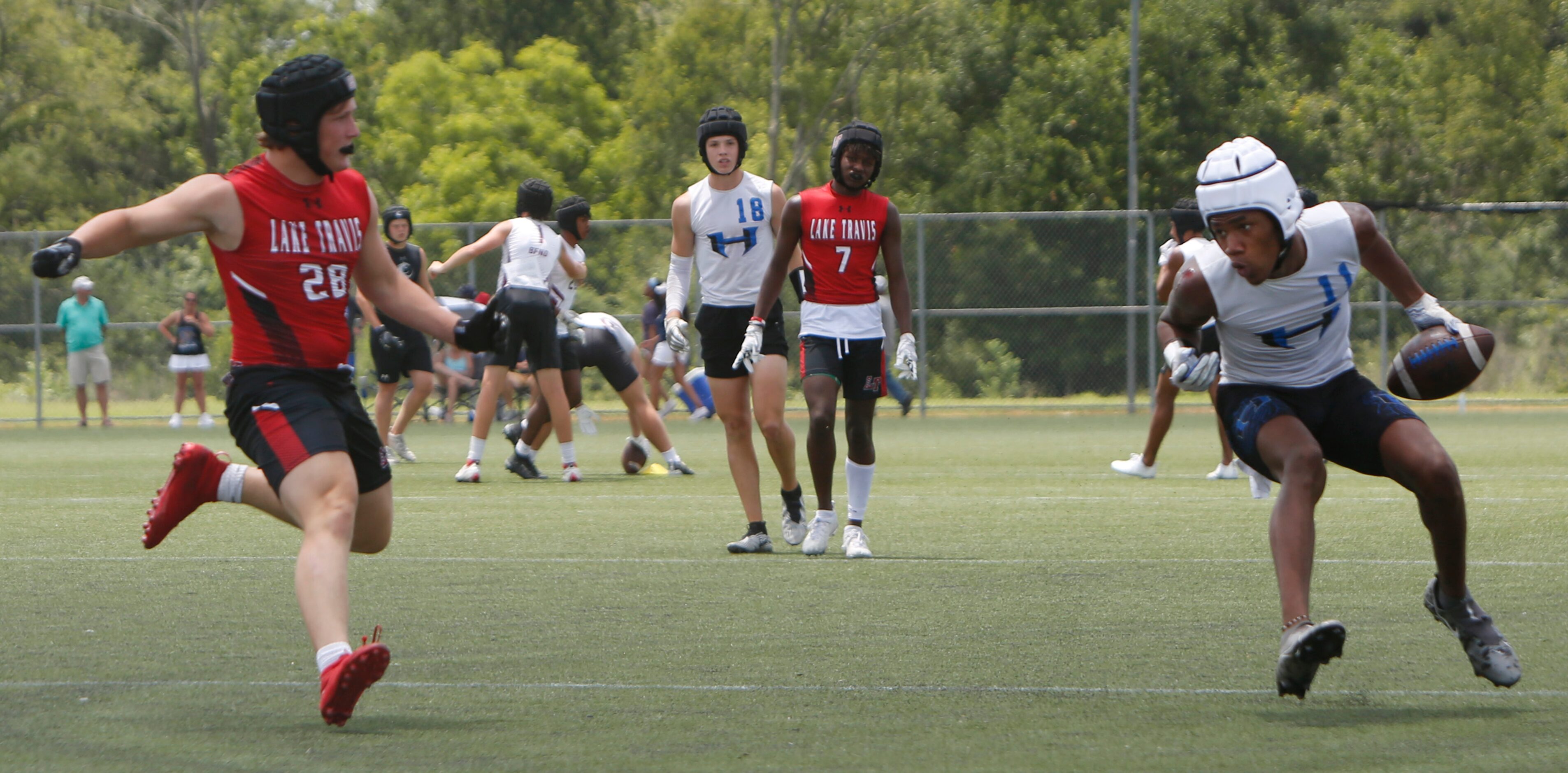 Hebron receiver Cobye Baldwin (11), right, reverses his field to avoid a Lake Travis...