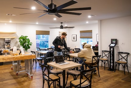 Beau Babcock, project manager, serves a customer at Bonton Farms' new coffee shop. The shop...