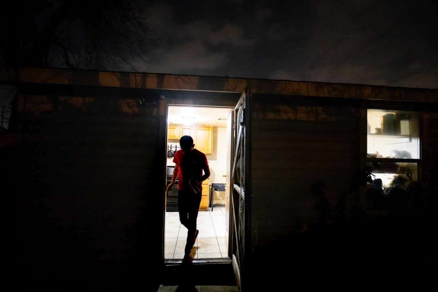 Carlos, a Guatemalan immigrant, walks out of the kitchen door of his home on Feb. 6, 2019,...