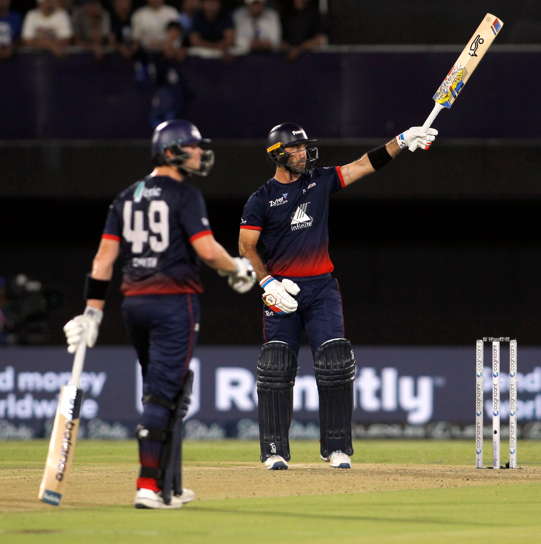 Washington Freedom's Glenn Maxwell (32), center, watches his long drive sail over the fence...