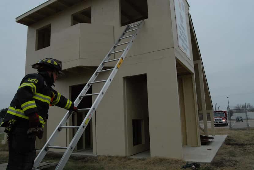 Jeremy Qualls  of The Colony Fire Department sets up a ladder for drills at the department’s...