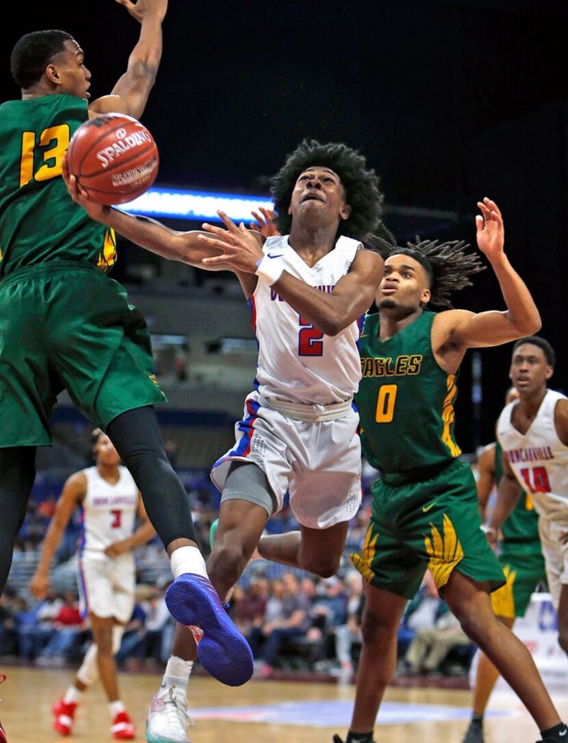 Duncanville's Ja'Bryant Hill #2 drives between Klein Forest's Calvin Solomon #13 and Klein...