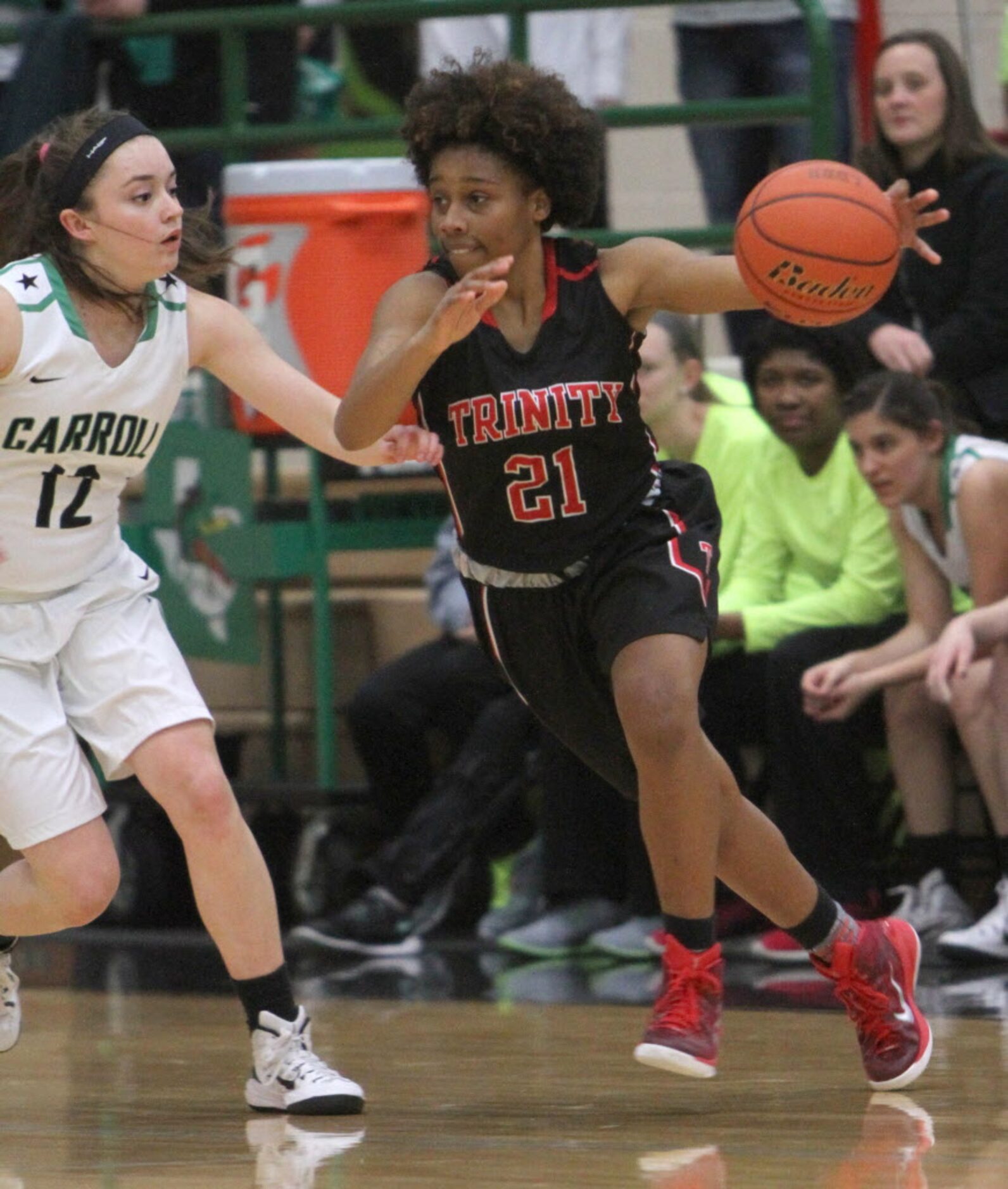 Euless Trinity guard Haleigh Talbert (21) drives around the defense of Southlake Carroll...