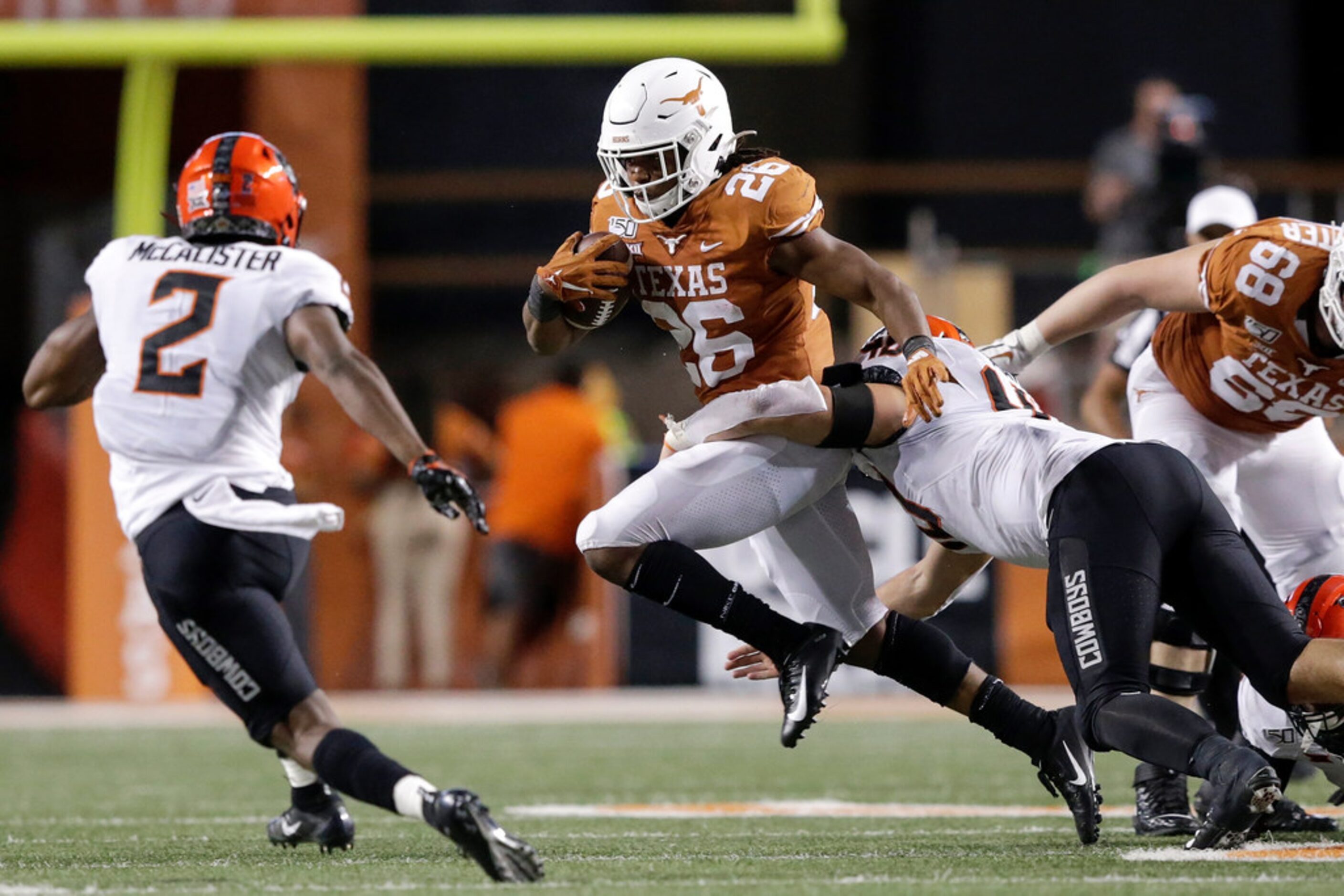 AUSTIN, TX - SEPTEMBER 21:  Keaontay Ingram #26 of the Texas Longhorns breaks a tackle by...