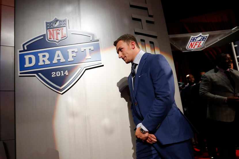 Johnny Manziel, from Texas A&M, walks on stage for a group photo with fellow draft prospects...