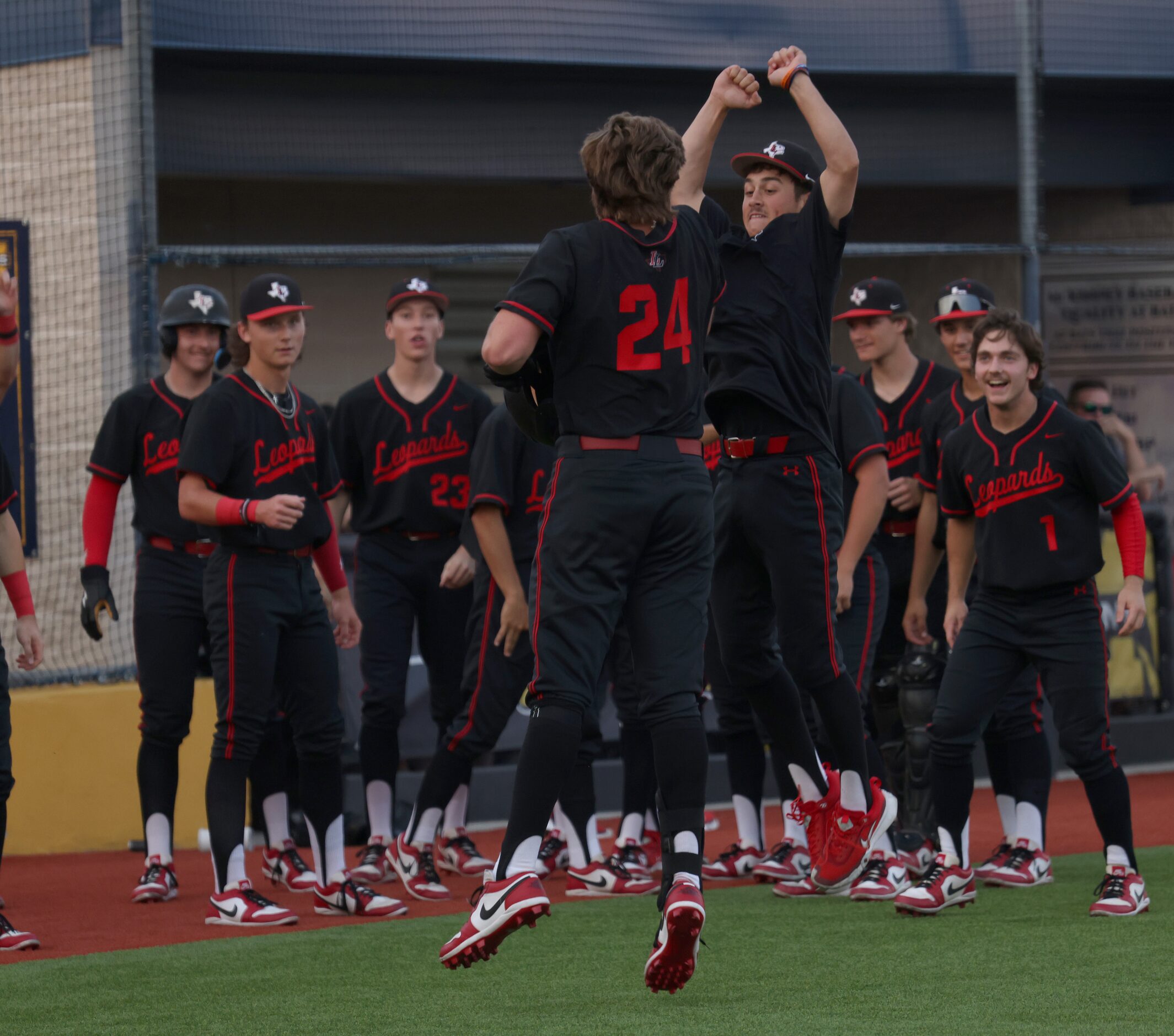 Lovejoy's Garrett Hutchins (24), center, celebrates with teammate Grant Harland, as others...