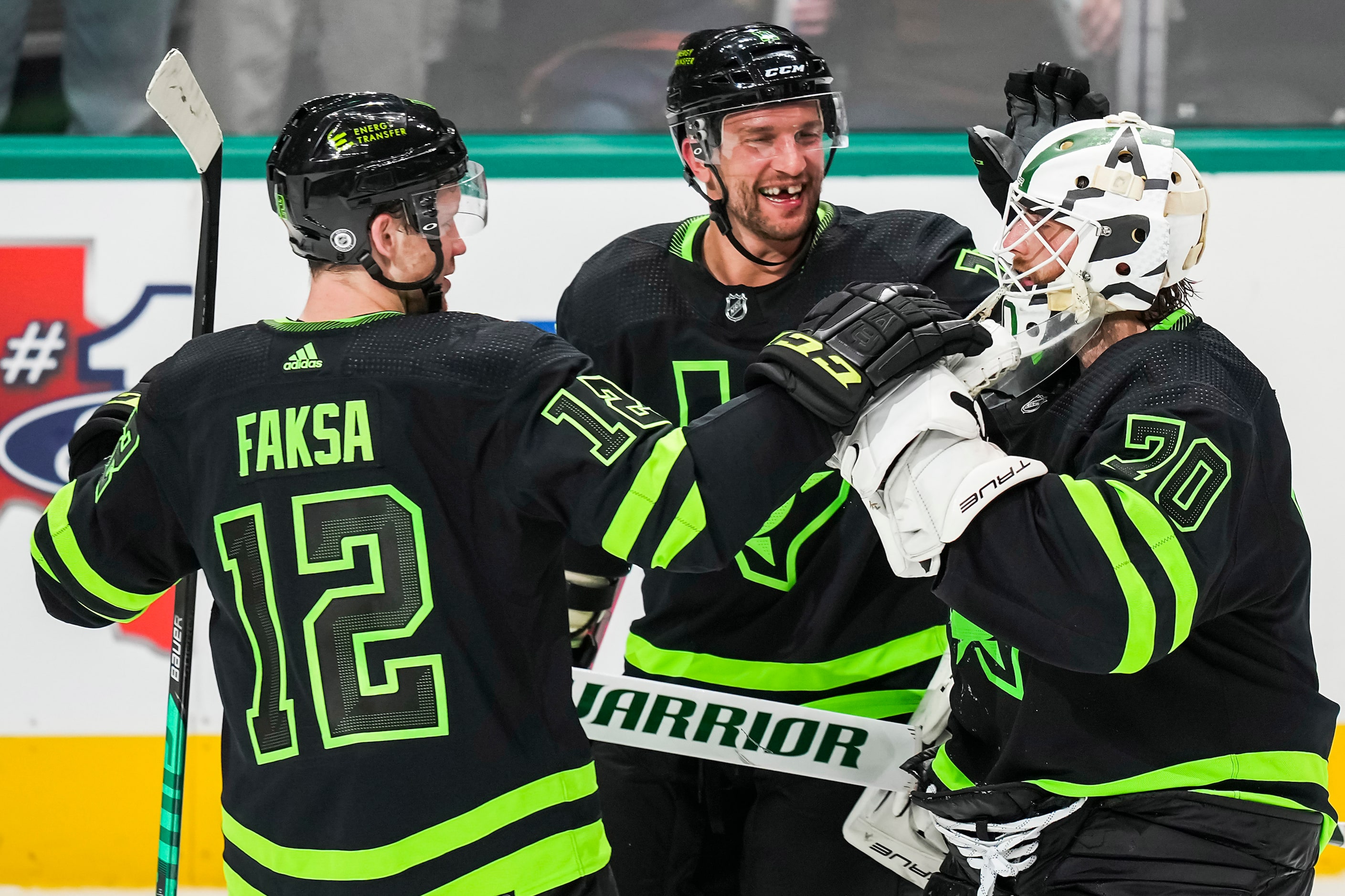 Dallas Stars goaltender Braden Holtby (70) celebrates with center Radek Faksa (12) and...