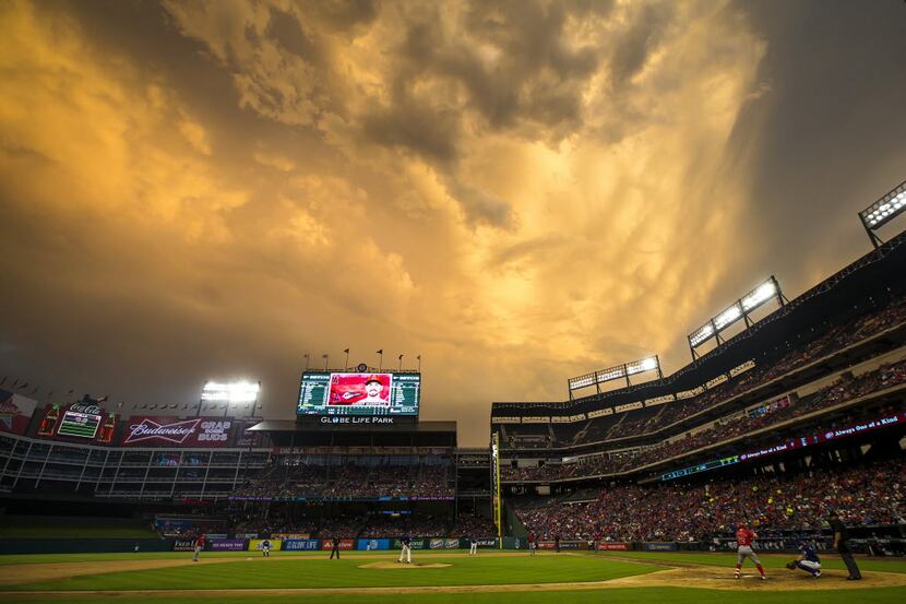 Storm clouds roll over Globe Life Park as the Texas Rangers face the Los Angeles Angels on...