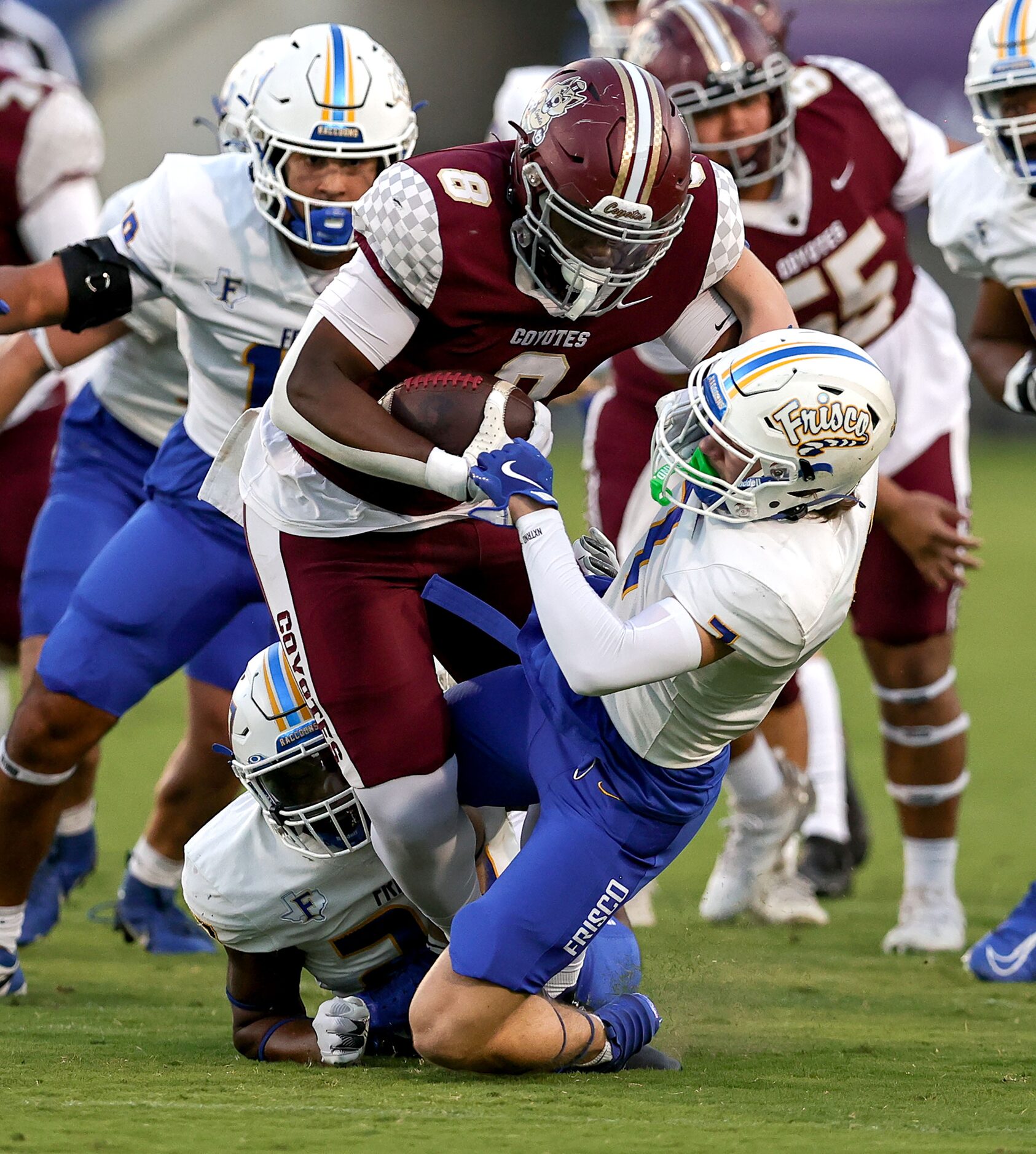 Frisco Heritage running back Danzel Okekeuche (8) tries to run over Frisco defensive back...