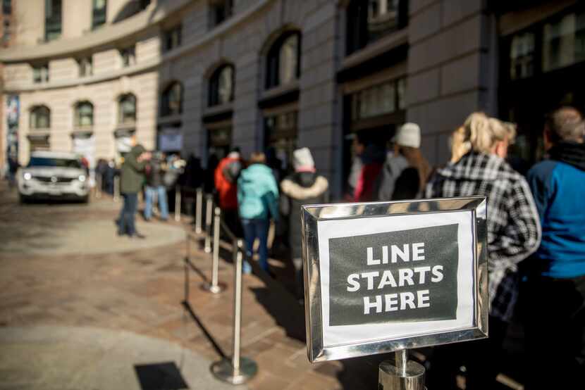 Furloughed workers wait in line to receive food and supplies from World Central Kitchen, the...