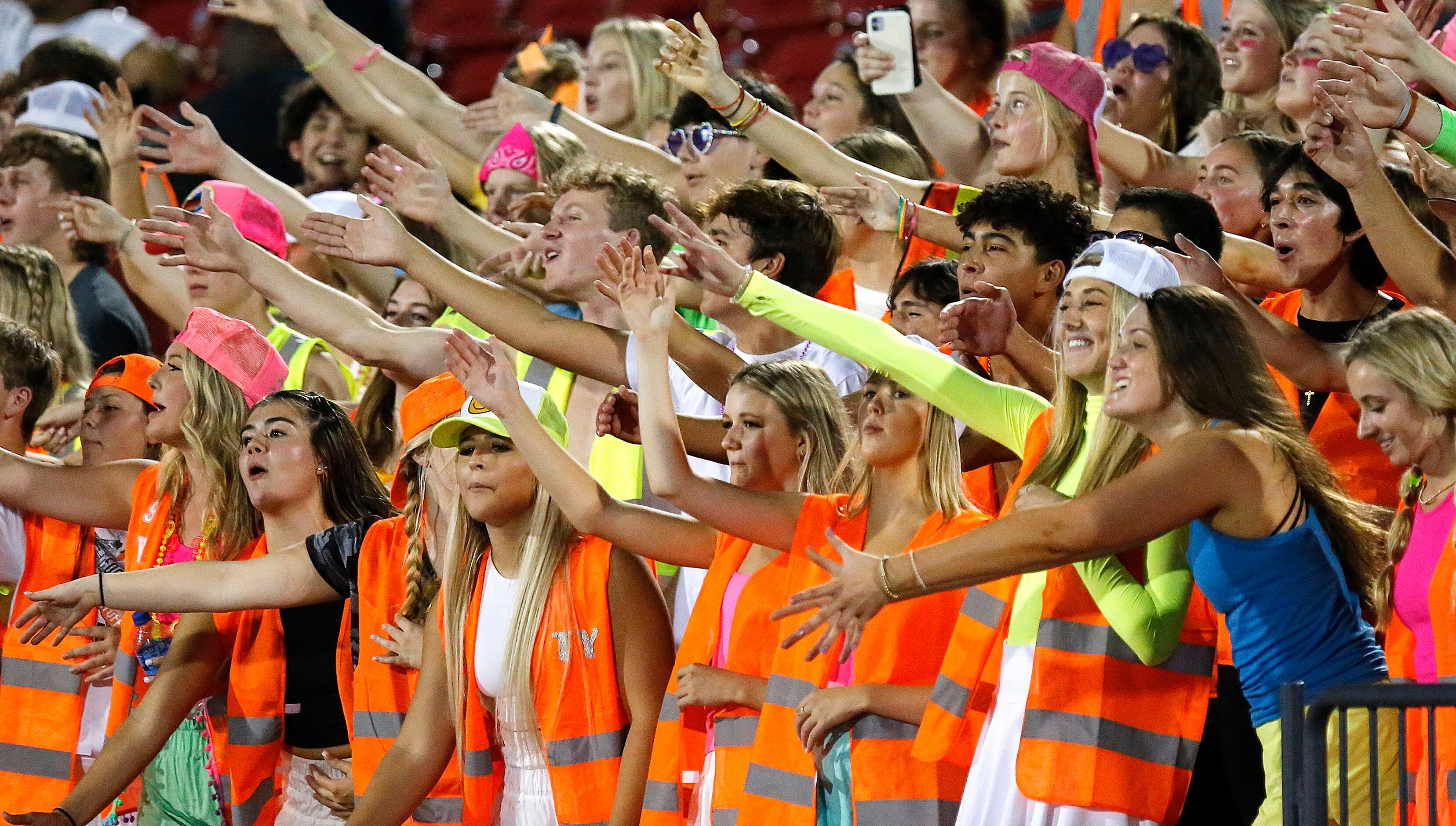 The Aledo High School student section reacts to a play on the field during the first half as...