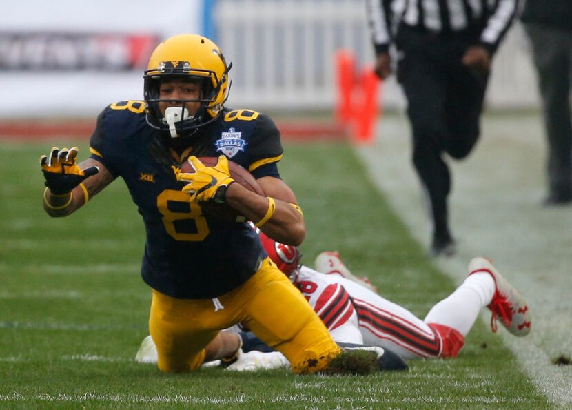 West Virginia Mountaineers wide receiver Marcus Simms (8) is tackled by Utah Utes defensive...