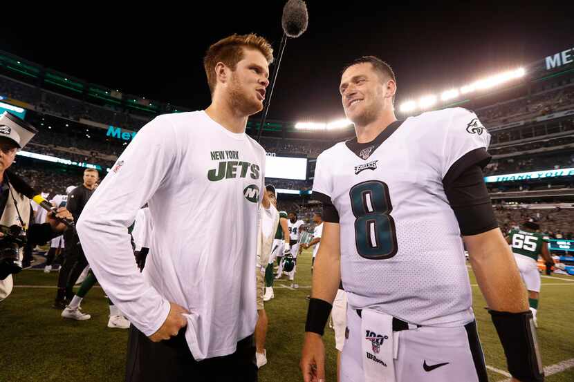 New York Jets quarterback Sam Darnold, left, talks to Philadelphia Eagles quarterback...