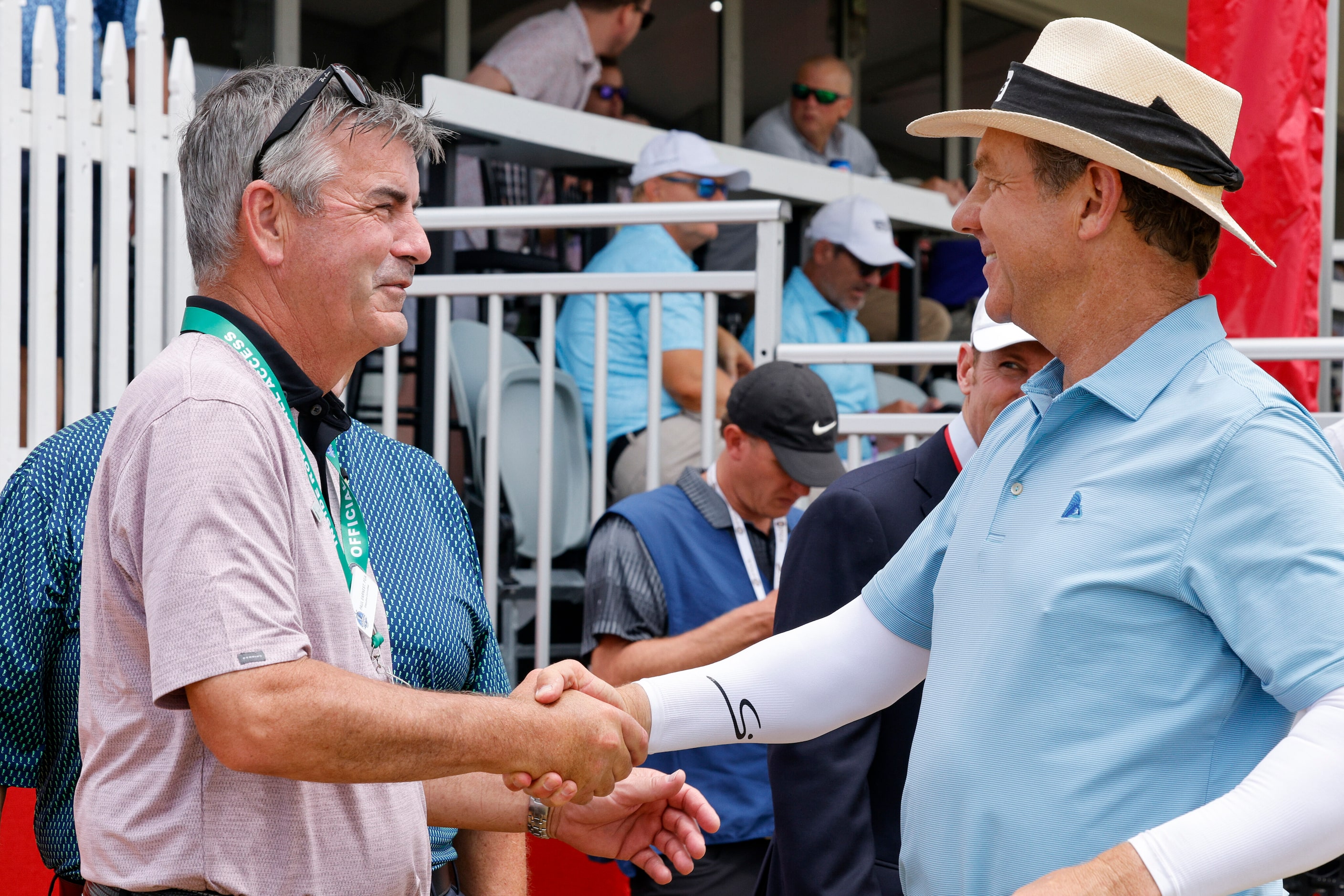 Preston Trail golf pro Cameron Doan (right) shakes hands with Paul Earnest, PGA Director of...