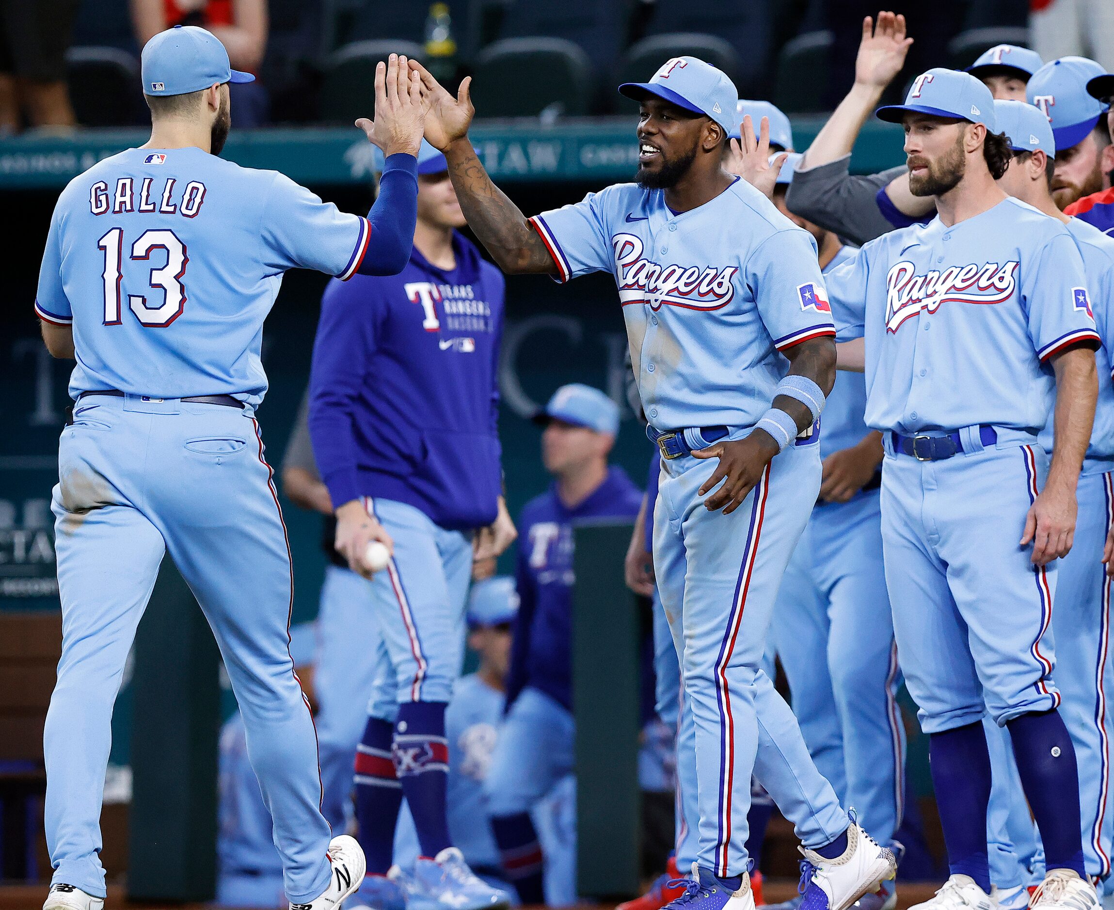 Texas Rangers right fielder Adolis Garcia (right) congratulates Joey Gallo (13) after their...