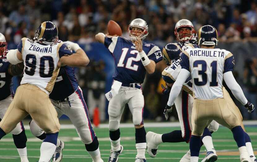 FILE - In this Feb. 3, 2002, file photo, New England Patriots quarterback Tom Brady (12)...