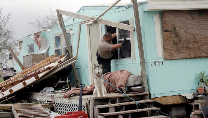 An inspector climbed through a window to check a home damaged by Hurricane Harvey on Sunday...