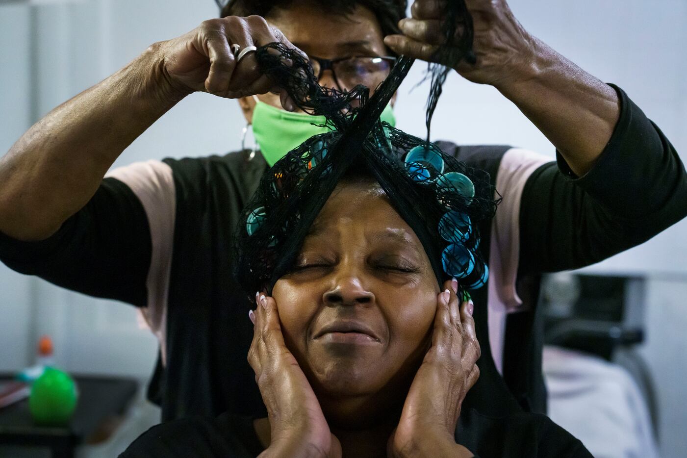 Earnestine Tarrant styles the hair of Altha Hearne at her hair salon in South Dallas on her...