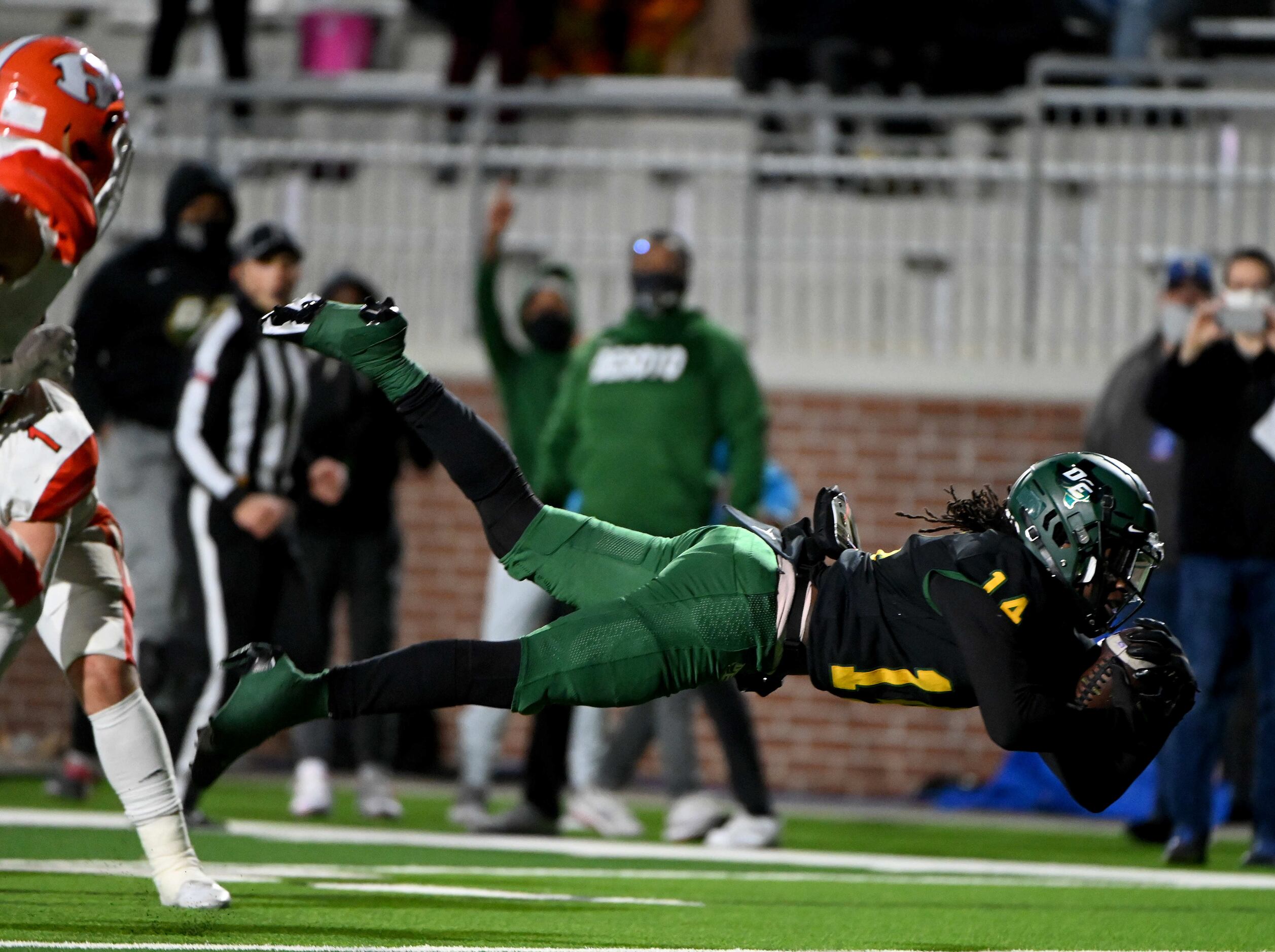DeSoto’s Robert Richardson dives for extra yardage in the first half of a Class 6A Division...