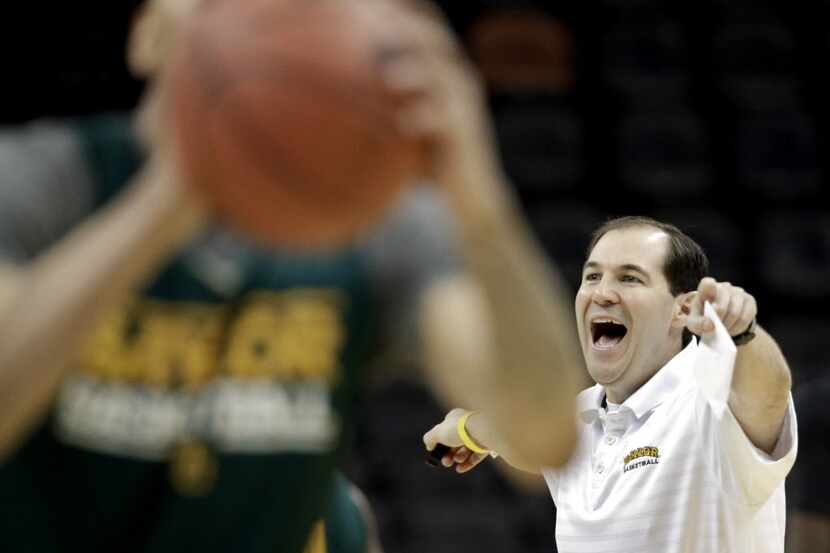 Baylor coach Scott Drew, right, calls out instructions during practice for the NCAA college...