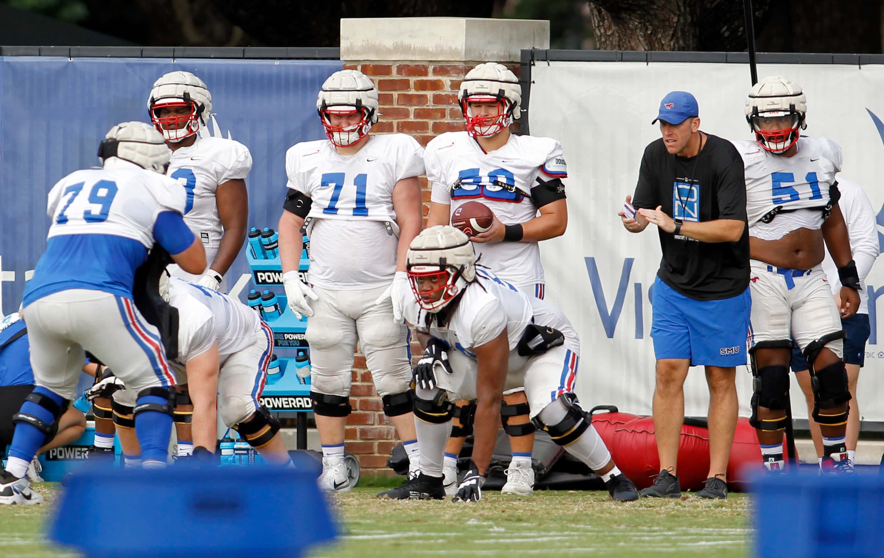 Members of the SMU Mustangs offensive line work through a drill during a team practice...