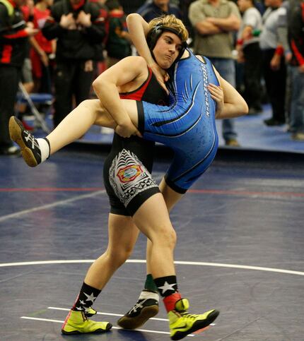 Euless Trinity's Mack Beggs (left) wrestles Grand Prairie's Kailyn Clay on Friday during the...
