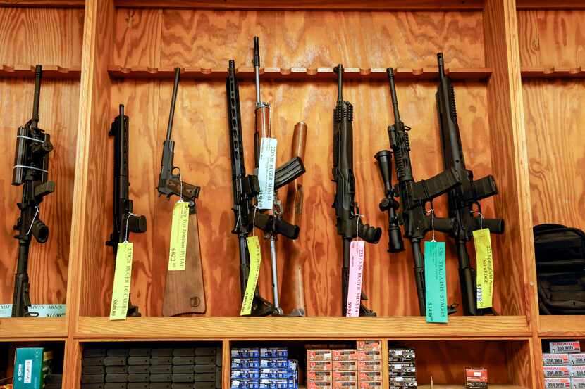 Various guns and ammo sit on display at TargetMaster, a gun shop and indoor shooting range...