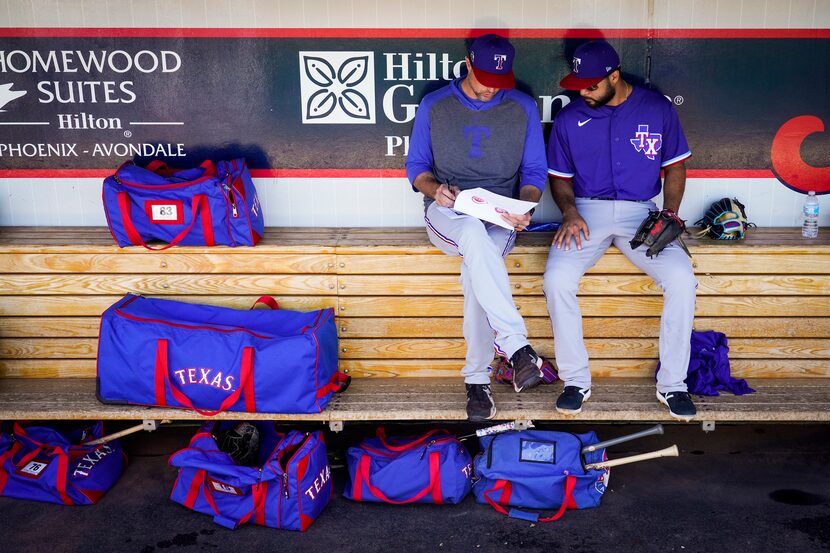 Texas Rangers infielder Isiah Kiner-Falefa (right) goes over defensive positioning reports...