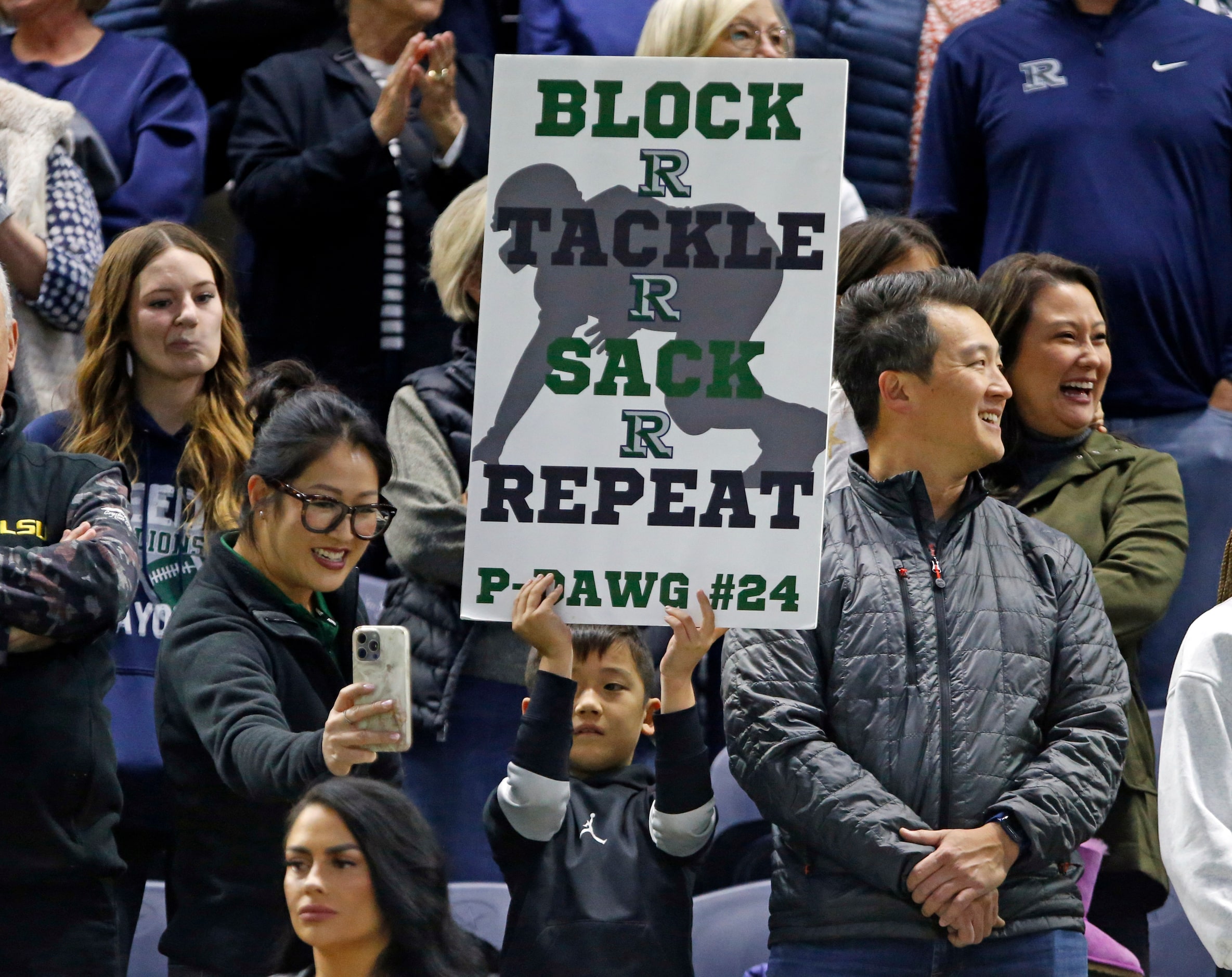 A young Frisco Reedy High fan with a sign gets his picture made before the start of a high...