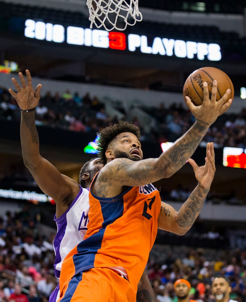 3's Company's Andre Emmett (2) goes up for a shot ahead of 3 Headed Monster's Qyntel Woods...