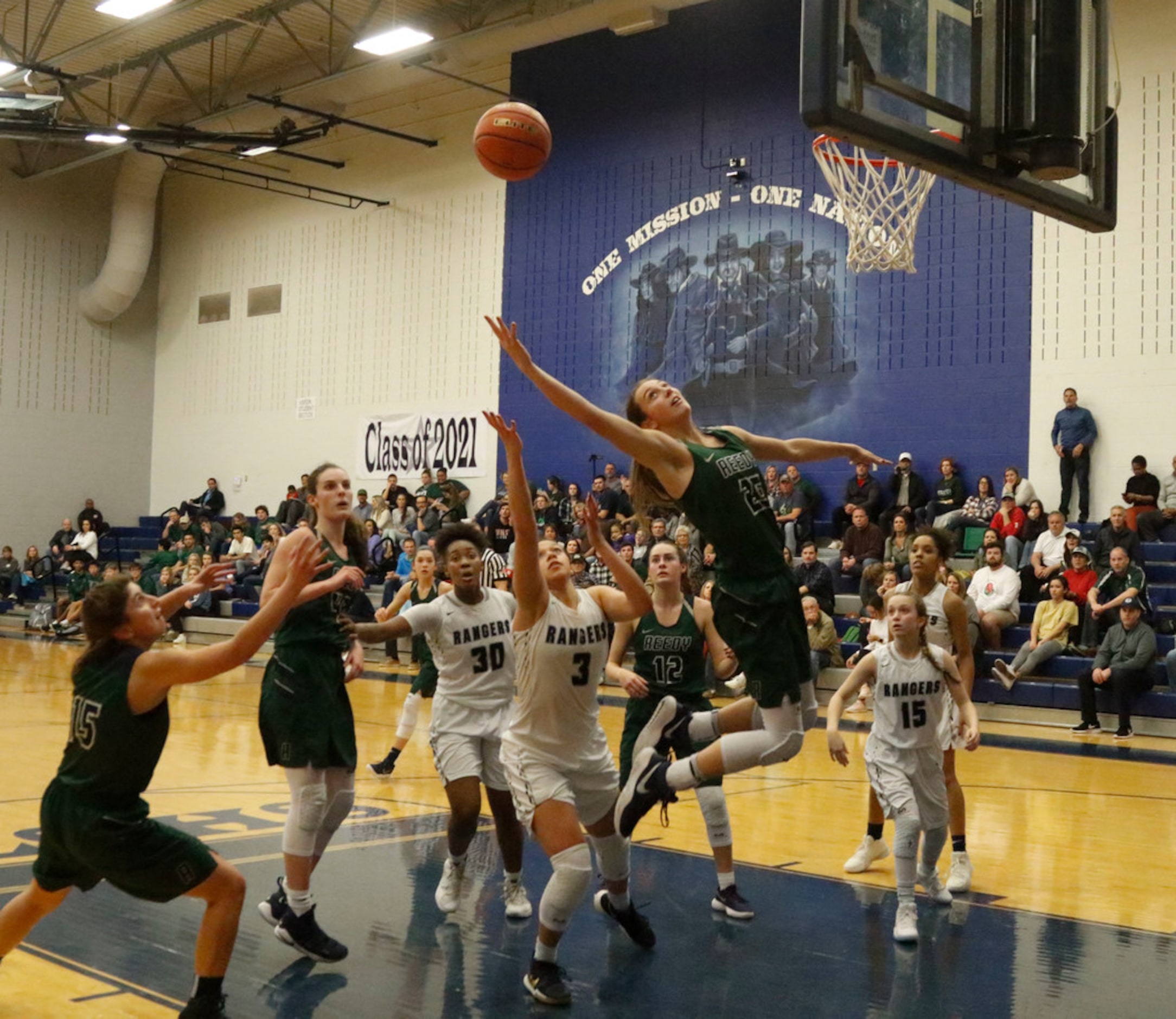 Frisco Reedy's Jadyn Bauss (25) leads the pack in a rebound attempt against Frisco Lone Star...