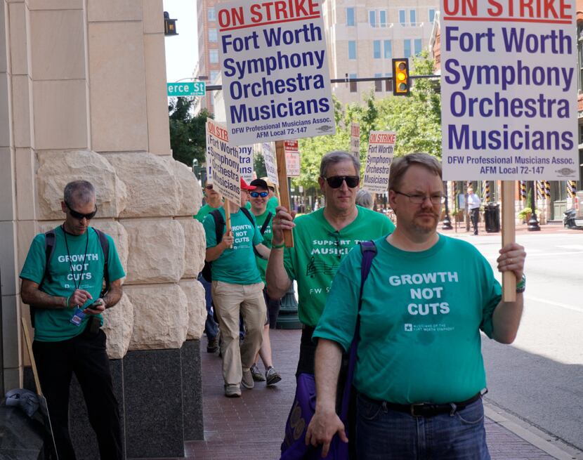 Fort Worth Symphony musicians walk the picket line in front of Bass Hall after calling a...